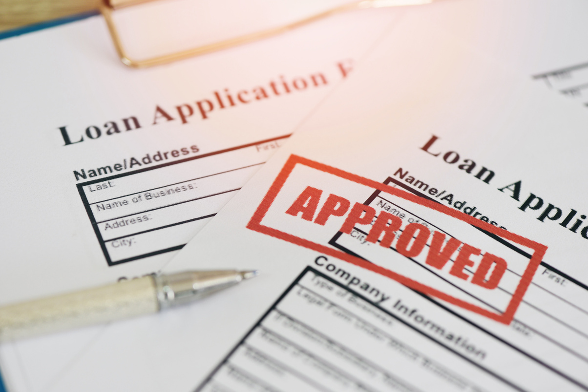 Loan approval, Loan application form with Rubber stamping that says Loan Approved, Financial loan money contract agreement company credit or person.